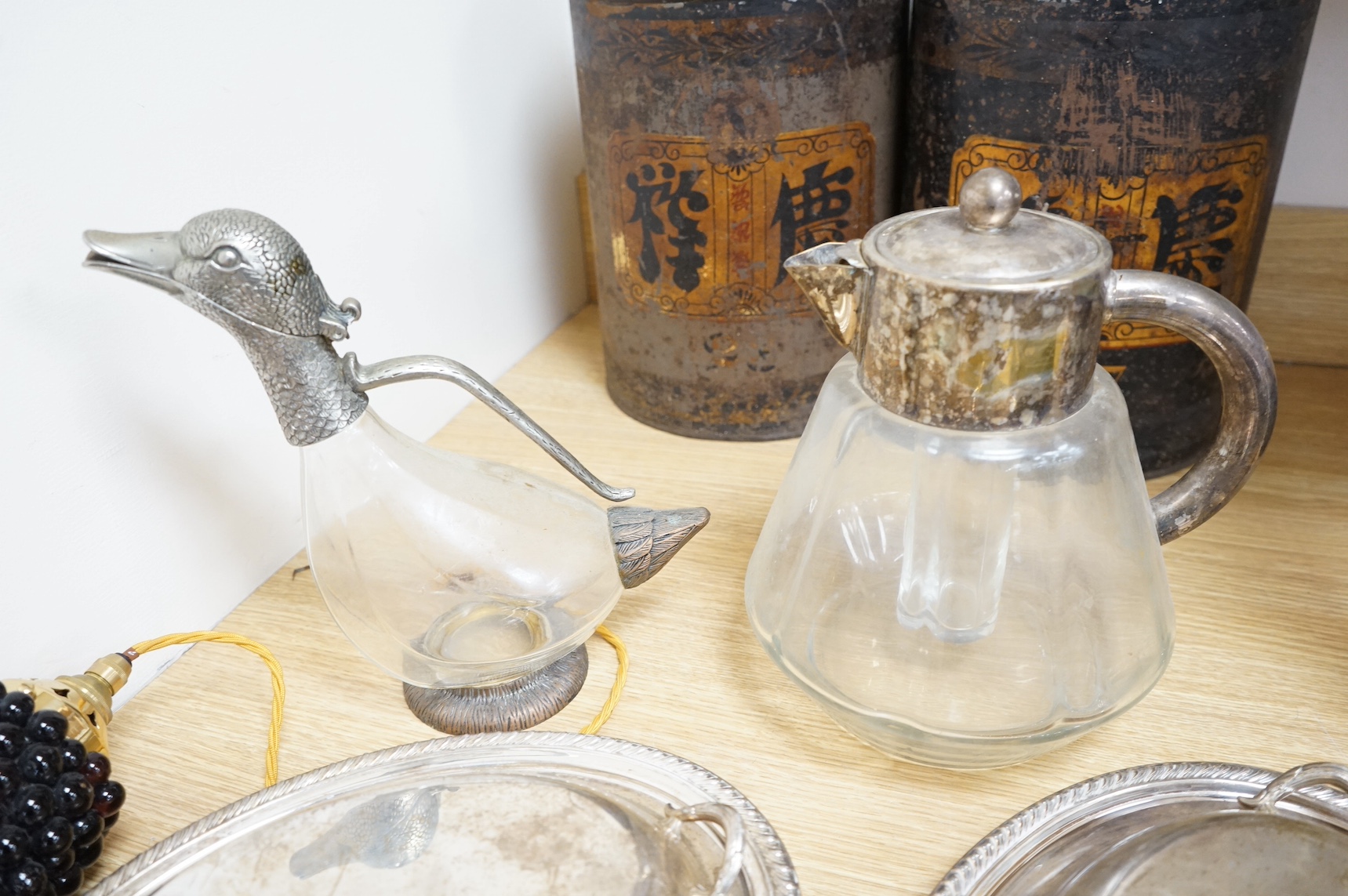 Silver plated ware to include a plated novelty duck decanter and two entree dishes and covers. Condition - fair